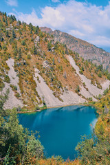 Obraz premium Lake in the mountains. Pond in the hills in Kyrgyzstan. Happy international mountain day.