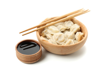 Bowl with dumplings and chopsticks, and soy sauce isolated on white background
