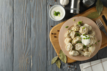 Composition with tasty dumplings on wooden background, top view