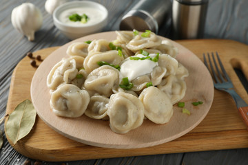 Composition with tasty dumplings on wooden background, close up
