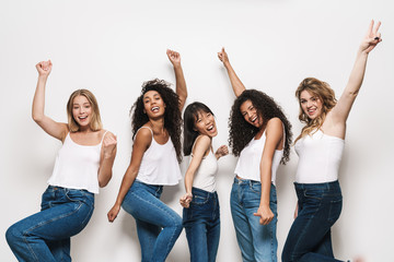 Image of excited multinational women smiling and gesturing peace