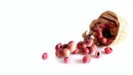 Manila tamarind in bamboo basket on white background.