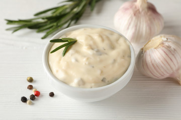 Bowl of garlic sauce, ingredients on white background, space for text. Top view