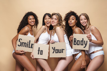 Image of pleased multinational women posing with placards