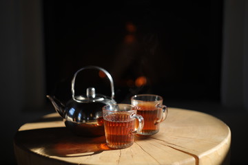 cup of tea and teapot on wooden table