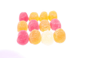 Multicolored tasty marmalades closeup on a white background.