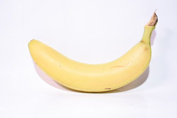 One yellow tasty healthy banana close-up on a white background.
