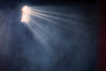 stadium lights and smoke against dark night sky background © ververidis