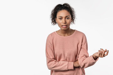 Serious african young woman isolated on white background looking at camera