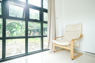 Fototapeta na wymiar Modern wooden cloth fabric sofa in living room with curtain window background