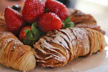 croissants with strawberries and coffee
