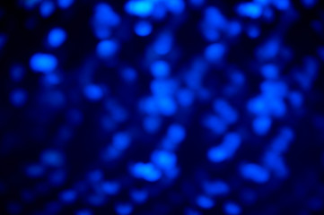 Blue and purple space blurred three-dimensional bokeh on dark blue background , neon juicy bright colors, abstract background