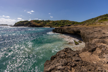 Fototapeta na wymiar Sainte-Anne, Martinique, FWI - Ferré Cape - Waves on the rocks in Pointe La Rose