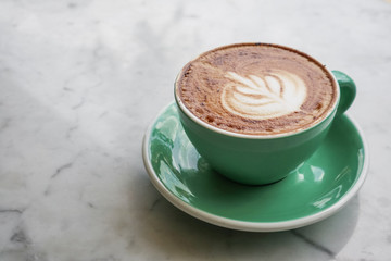 A cup of coffee with latte art on top