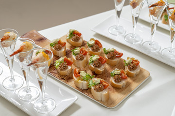 Catering, snacks on the table. Mini Sandwiches with pate and tomatoes, decorated with salad.
