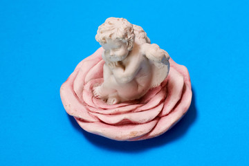 gypsum angel figurine on a blue background.