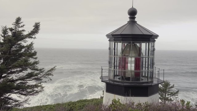 Large waves roll ashore behind the Cape Meares lighthouse on the Oregon coast