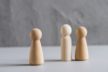 Love triangle concept. One wooden men and two woman. Divorce. Treason.