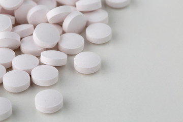 Fototapeta na wymiar Pills tablets vitamins capsules drugs white close up macro shot