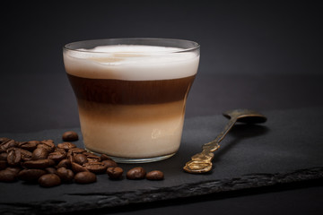 Coffee cappuccino and coffee beans on black background