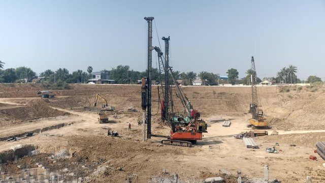 drilling piles with heavy machineries at the construction site