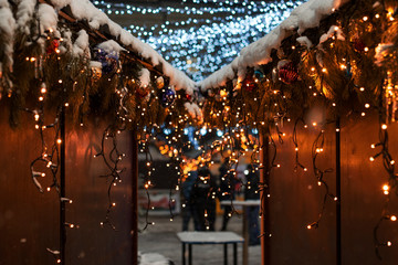 Festive lights, Christmas and New Year background, beautiful bokeh, garlands, spruce branches and Christmas balls.