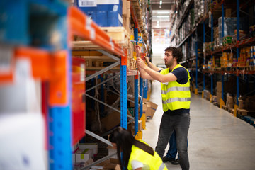 Workers in warehouse review the goods	