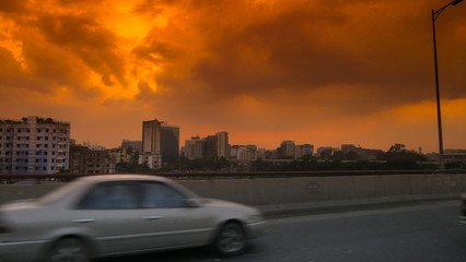 Side view of a car on the streets of Dhaka, Bangladesch at sunset