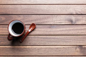 Cup of coffee on wooden table. Top view with copy space, flat lay