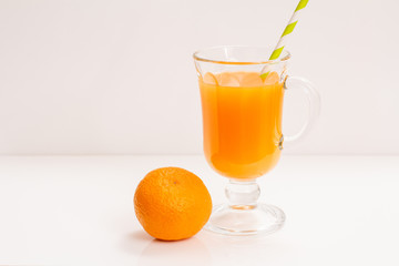 Fresh tropical fruits and glass of juice on white background.