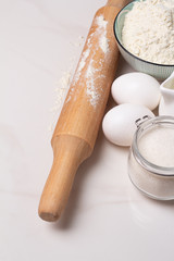 flour, eggs milk and sugar and rolling pin