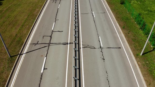 aerial motion over highway with streetlights on sunny day