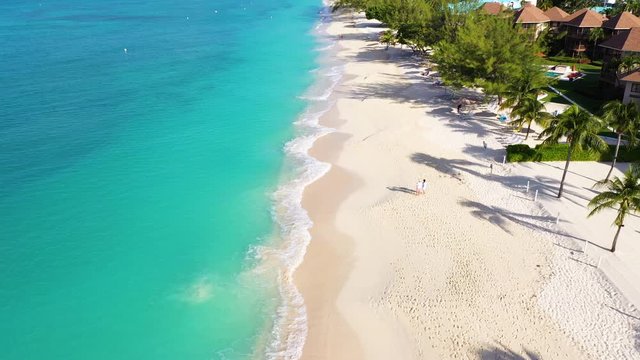 aerial drone footage of seven mile beach on the island of grand cayman in the cayman islands in the tropical waters of the caribbean sea during winter