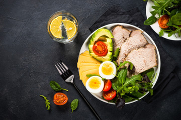 Keto diet plate on black stone table.