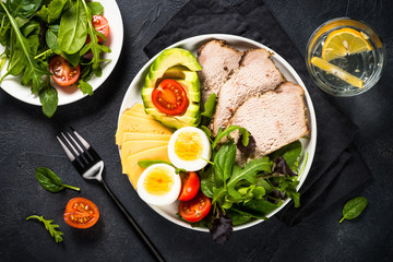 Keto diet plate on black stone table.