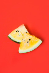 cut off triangular slices of ripe yellow watermelon on white background