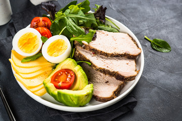 Keto diet plate on black stone table.
