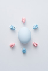 Easter bunnies around a big egg. abstract image in easter holiday concept