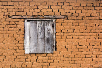 Old brick wall with wooden window.