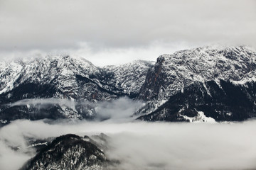 Beautiful fog in the high, rocky mountains in winter.