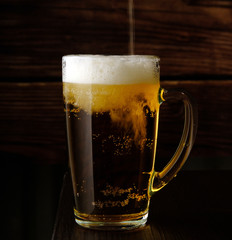 beer is poured into a beer mug