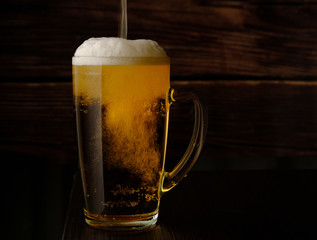beer is poured into a beer mug