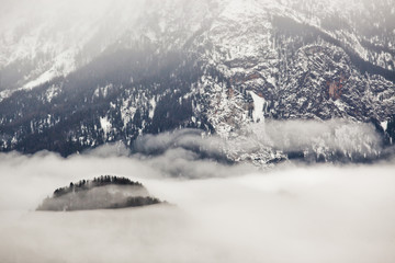 Fototapeta na wymiar Beautiful fog in the high, rocky mountains in winter.