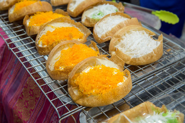 Thai coconut pancake in pan (Khanom thang taek) topped with sweet egg floss, Most famous of Thai dessert, Street food in Thailand.