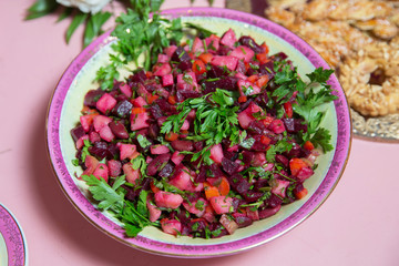 Fresh homemade Beetroot salad Vinaigrette in a white bowl. Vegetable salad with beets on table ready for eat . beetroot salad with Carrots, Pickles and green Onion in white plate .