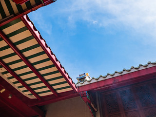 Fototapeta na wymiar Chinese Temple Rooftop with blue sky