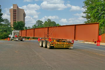 A huge steel beam for bridge construction on a truck