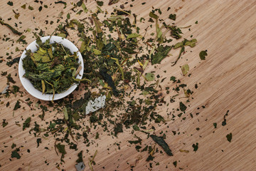 Dry grass is scattered on a white oak board and poured into a white bowl. Decoration for the kitchen.