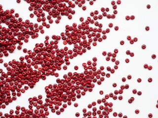 red brown wooden beads on a white wooden background, Can use as background or wallpaper.