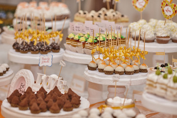 the wedding table is decorated with various beautiful desserts